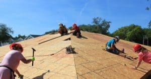 Women Build volunteers nailing on roof