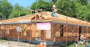 Home under construction with Women Build Week banner